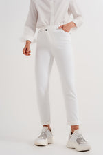 SLIM JEANS WITH ASYMMETRIC BUTTON